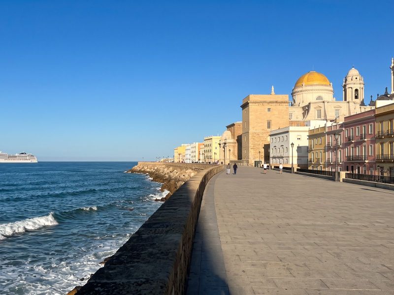 The Campo del Sur seafront in Cádiz with colourful façades and the cathedral’s golden dome