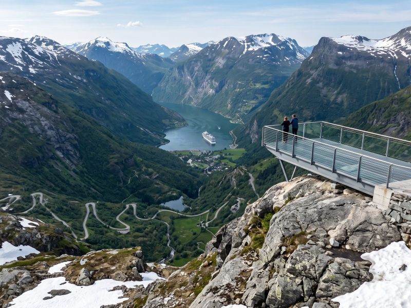 Uitzicht vanaf de Dalsnibba over het dal richting het Geirangerfjord, met sneeuw op de top